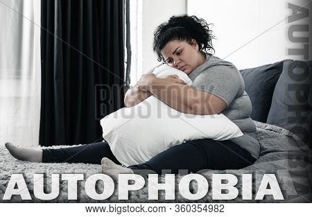 Depressed Overweight Woman Sitting Alone On Bed At Home. Autophobia