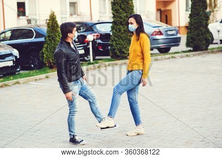 Young Couple Greeting With Feet. Coronavirus Epidemic. Covid 19 Concept. Coronavirus Prevention.