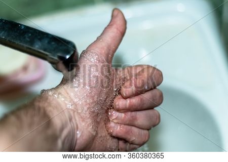 Male Hand. Hand Washing With Water In The Sink.