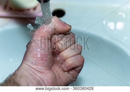 Male Hand. Hand Washing With Water In The Sink.