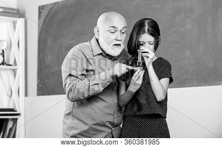 Wisdom. Mature Teacher Look Through Magnifying Glass Tube On Lime. Small Girl Explore Fruit Slice. S