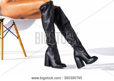 Black Hessian Boots On The Feet Of A Model On A White Background With Shadows. Jackboots. Studio Sho