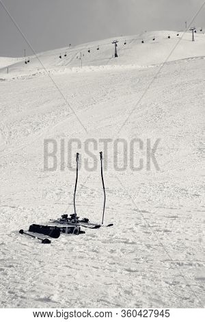 Skiing Equipment: Ski Poles, Skis On Snowy Slope, Chair Lift And Gray Cloudy Sky At Background. Ski 