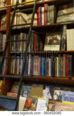 Many Different Books On The Shelves In The Store. Blurred. Background. Vertical.