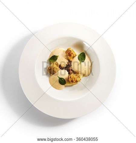 Scallops in crispy breading top view. Served roasted seafood dish with potato mousse and fish ragout in plate. Gourmet culinary, gastronomy. Restaurant food portion, cooked main course