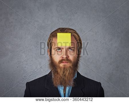 Serious Worried Business Man Looking Up To The Sticker Stick On Forehead