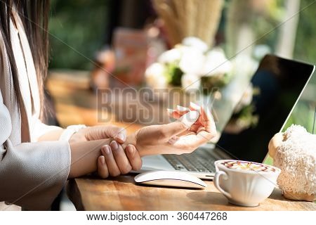 Closeup Woman Holding Her Wrist Pain From Using Computer. Office Syndrome Hand Pain By Occupational 