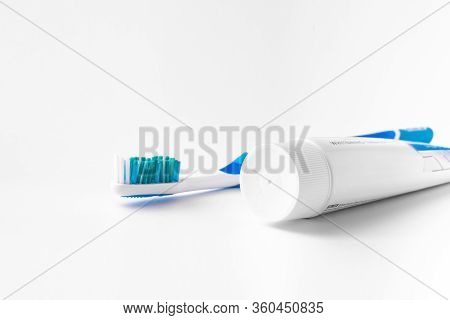 Toothbrush And Dental Floss On A White Background. The View From The Top.