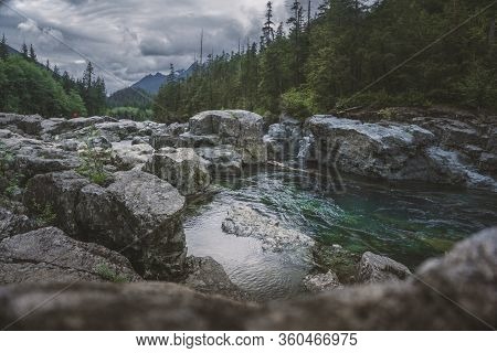 The Beauty Of Wally Creek Pullout. Forest, Wild River, Rocks And Trees On Vancouver Island In Canada