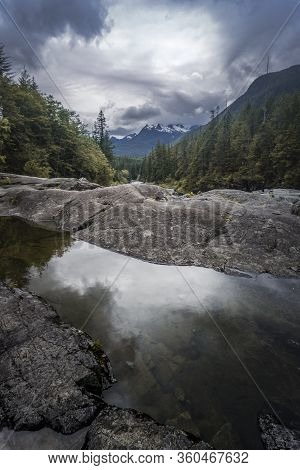 The Beauty Of Wally Creek Pullout. Forest, Wild River, Rocks And Trees On Vancouver Island In Canada