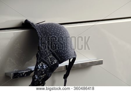 Beautiful Fishnet Black Bra With White Polka Dots And An Open Underwear Drawer Close-up.