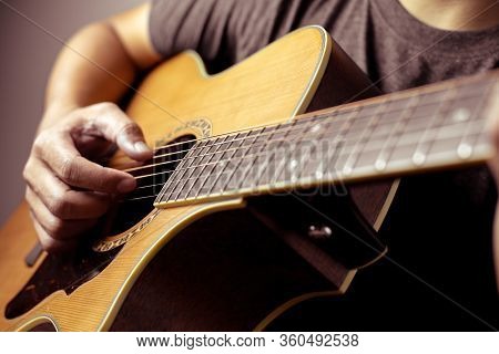 Musicians Are Playing Acoustic Guitar.