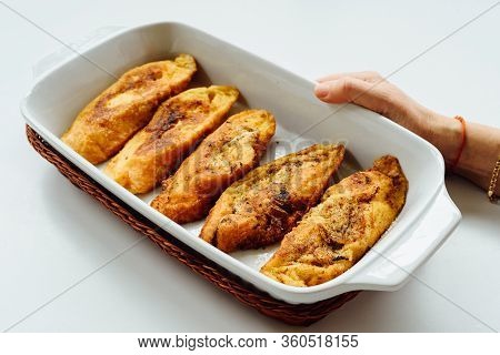 Female Hand Holding A Tray With Torrijas, A Typical Spanish Sweet Fried Toasts Of Sliced Bread Soake