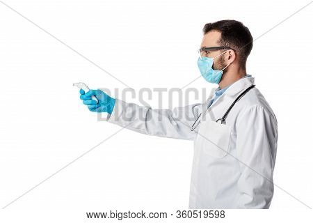 Side View Of Doctor In Medical Mask And White Coat Holding Pyrometer Isolated On White