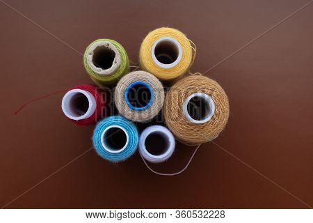 Babin Sewing Thread On A Brown Isolated Background, Top View
