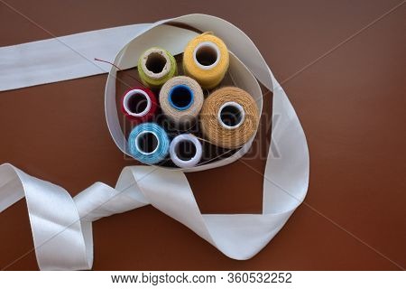 Babin Sewing Thread On A Brown Isolated Background, Top View