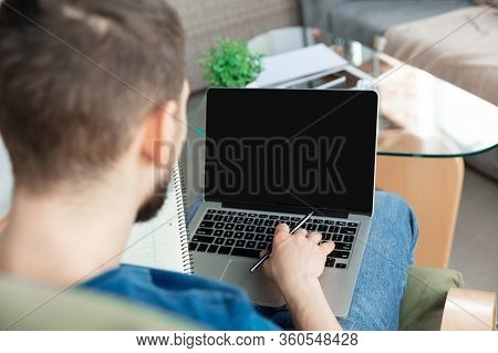 Young Focused Man Studying At Home During Online Courses Or Free Information By Hisself. Becomes Pro