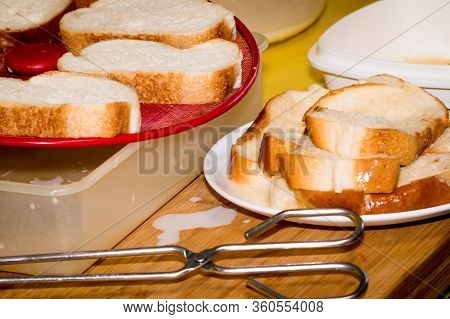 Putting Bread With Milk To Make A Typical Spanish Food, Torrijas.