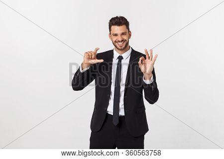 A Confident And Successful Handsome Businessman With Black Suit And Mustache. In A Suit Shows A Sign