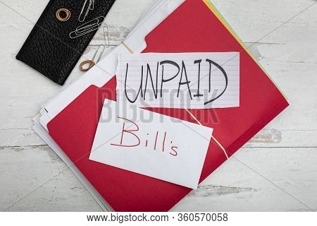 Flat Lay Background Signs With Signs Unpaid Bills Laying On Red File Folder Filled With Monthy Payme