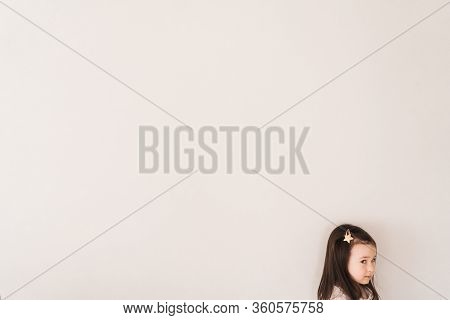 Place For Text About Children. A Little Girl Is Standing In The Corner Of The Frame. Conceptual Phot