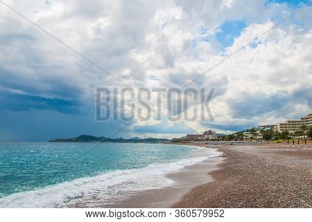 Sand And Pebble Beach On The Coast In Faliraki, Kallithea. Rhodes, Greece