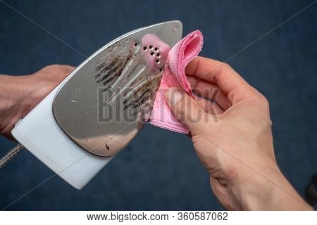 Removal Of Melted Fibers And Scrap Hardened Plastic On The Soleplate. Cleaning The Surface Of The Ir