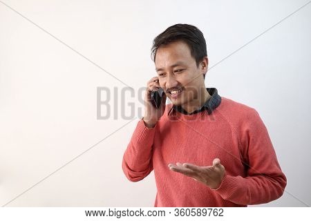 A Man Talking Over The Phone In A Happy Mood Isolated In White Background With Space For Text