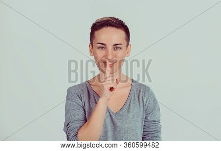 Closeup Portrait Happy Young Woman Placing Finger On Lips Asking Shhhhh, Quiet, Silence Isolated On 