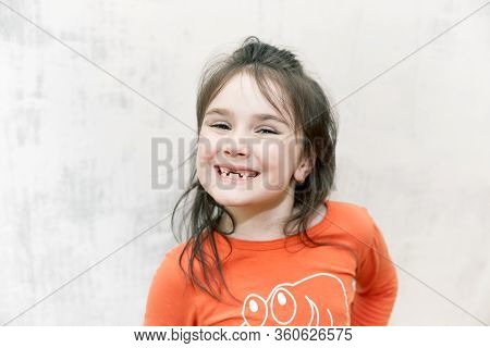 Close Upportrait Of Smiling Happy Toothless Girl Dropped Her Milk Teeth On White Background
