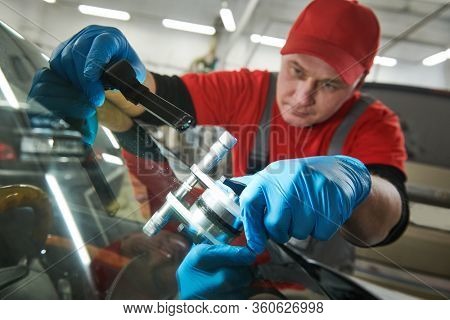 automobile windshield glass repair service. Car glass or chip crack repairing
