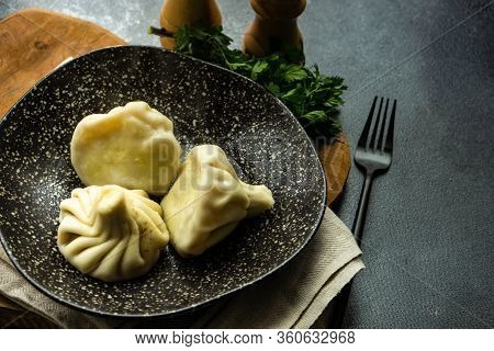 Traditional Georgian Khinkali Dish On Stone Background