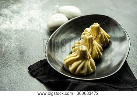 Traditional Georgian Khinkali Dish On Stone Background
