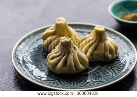 Traditional Georgian Khinkali Dish On Stone Background