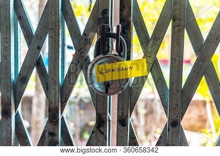 Lockdown Sticker On Door Lock Gate. Stay At Home Saying During Self-quarantine And Lockdown At Home.