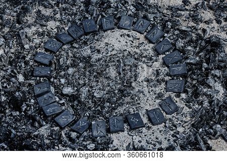 Circle Of 24 Norse Runes Stones On Ashes Background