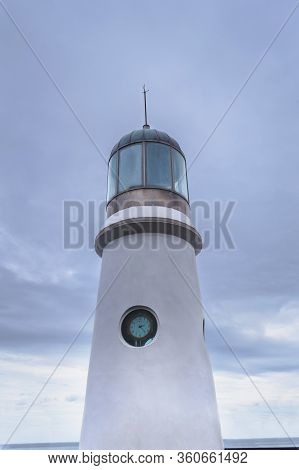 Small Lighthouse On Dongbaekseom Island With Overcast Skies On Background