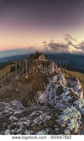 Rocky Mountain Peak At Sunset With A Beautiful Landscape And Vegetation Around. Top View From High A