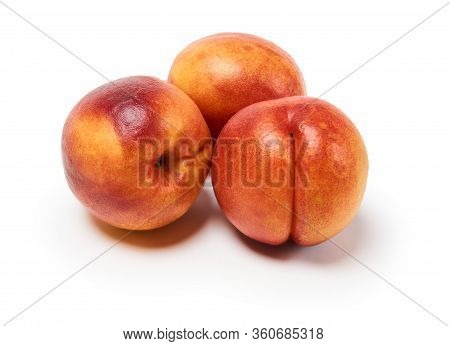 Three Ripe Nectarines On A White Background, Isolated With A Shadow