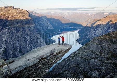 Trolltunga. Norway - 04.09.19: Happy Family On Trolltunga In Norway. Man And Girl Cuddle.