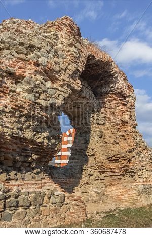 Ancient And New Architecture. Part Of A New Building In The Same Architectural Style Is Visible Thro