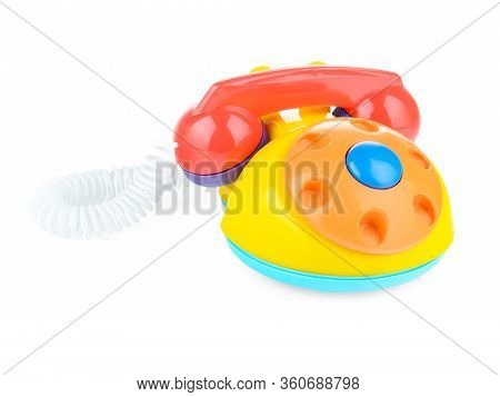 Childrens Home Plastic Phone On A White Background. Colorful Phone For Playing With Your Child. Cata