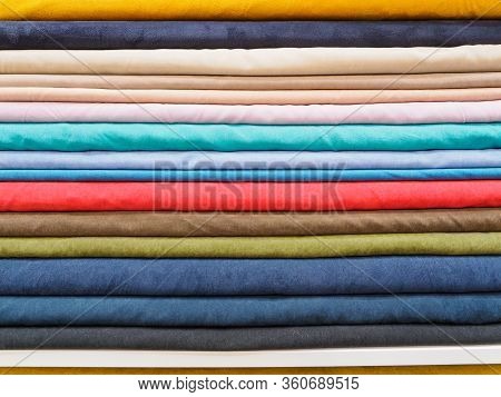 Samples Of Colored Natural Fabrics Close-up. Large Assortment Of Bright Fabrics In The Store. A Tail