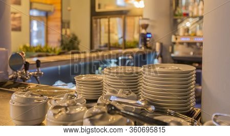 Bar Counter With Clean Dishes Close Up. Barroom In Restaurant, Ready For Work, Copy Space. Cafe Back