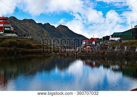 A Landscape View Of Tsomgo Lake, Also Called Changu Lake Surrounded By Stony Hills And Roads In Autu