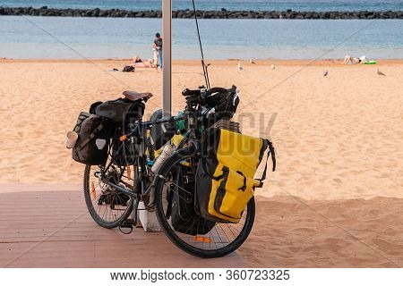Touring Bike Full Loaded Standing, Tourist Bike With Bags On The Beach Background, Concept Of Cyclin
