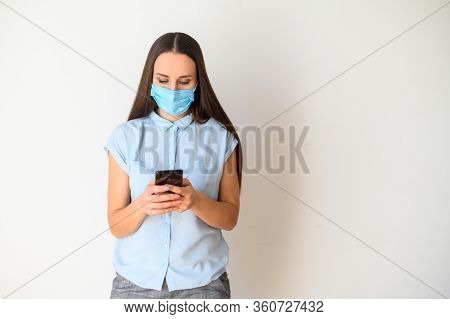 Protect Yourself From Epidemic, Communicate Remotely. A Young Woman In A Medical Mask On Her Face Is
