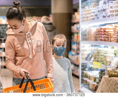 Mom And Kids Are Shopping At The Grocery Store.