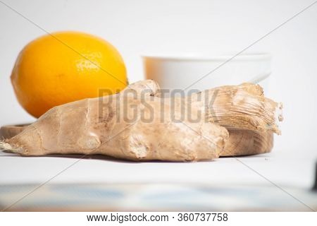 Composition Of Lemon, Ginger And Honey On A White Table.