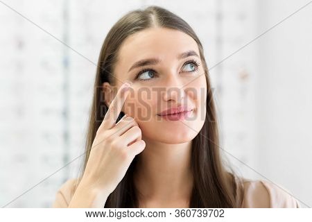 How To Apply Contact Lenses Concept. Close Up Portrait Of Young Woman Wearing Eye Lens, Looking Asid